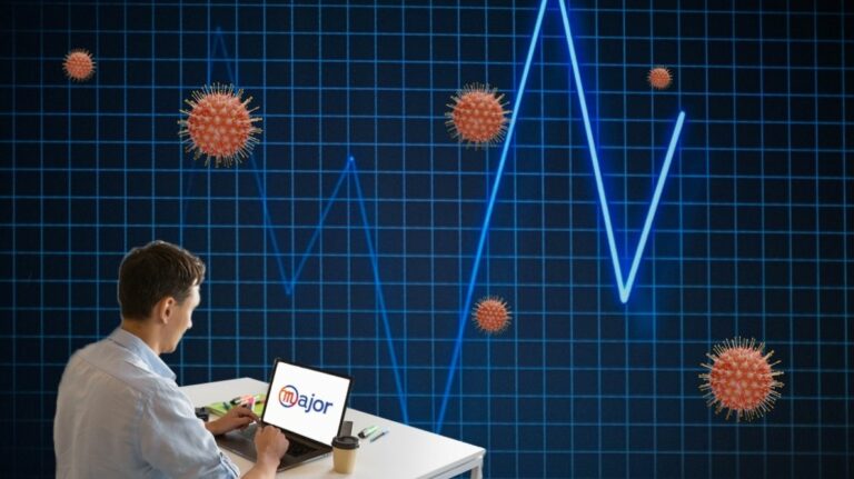 Un homme derrière son ordinateur devant un graphique de croissance et des virus