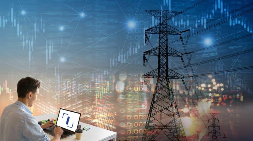 Un homme travaillant sur un ordinateur devant un pylône électrique